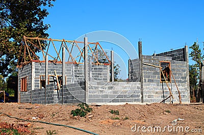 Your dream home. New residential construction house framing against a blue sky.