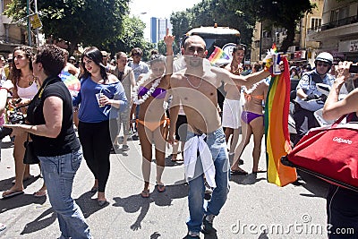 Youth dancing with rainbow flag at Pride Parade TA