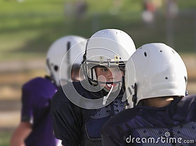 Youth football player concentrating on the play