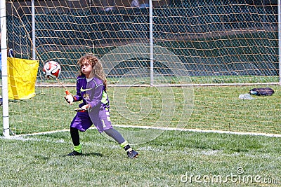 Youth Soccer Football Goalie Catching the Ball Duing a Game