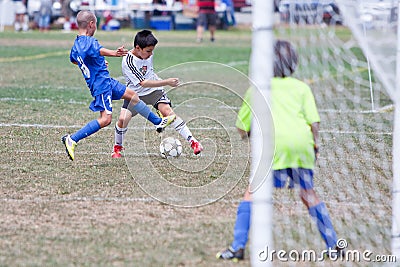 Youth Soccer Football Players Fight for the Ball