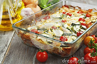 Zucchini baked i with chicken, cherry tomatoes and herbs