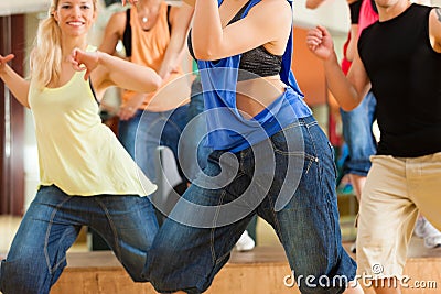 Zumba or Jazzdance - people dancing in studio