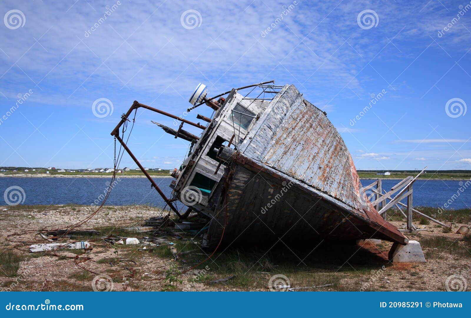 An old fishing boat, rotting on its side, in Flower’s Cove 