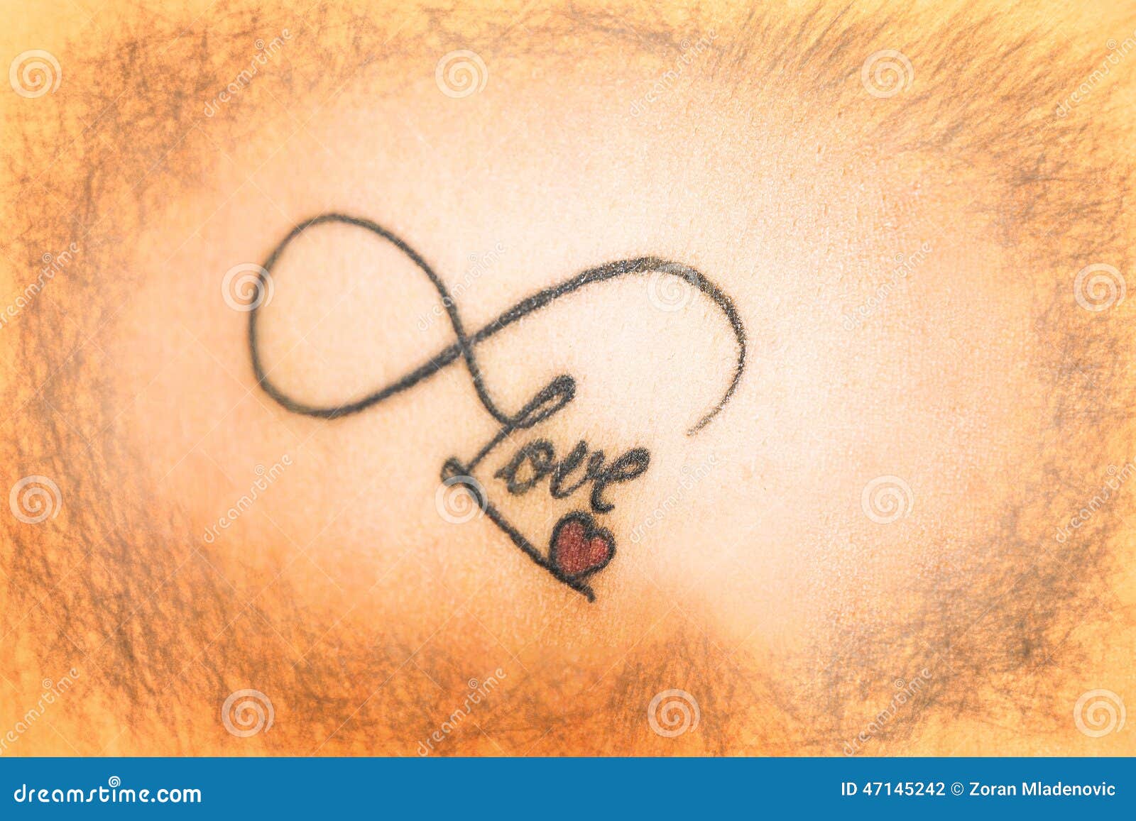 abstract tattoo on skin that says love with smal red heart abstract tattoo on skin that says love with smal red heart