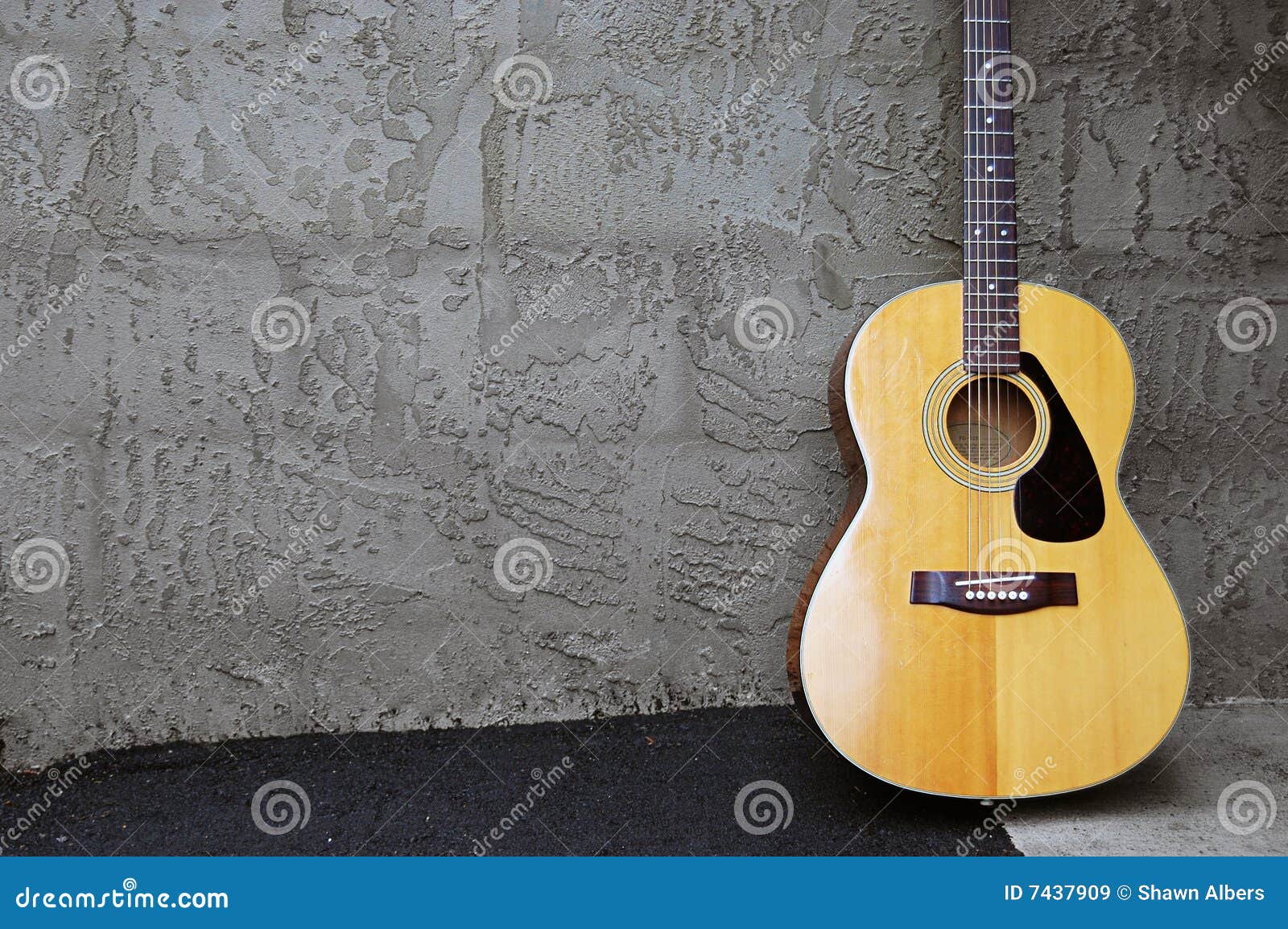Acoustic Guitar on Block Wall