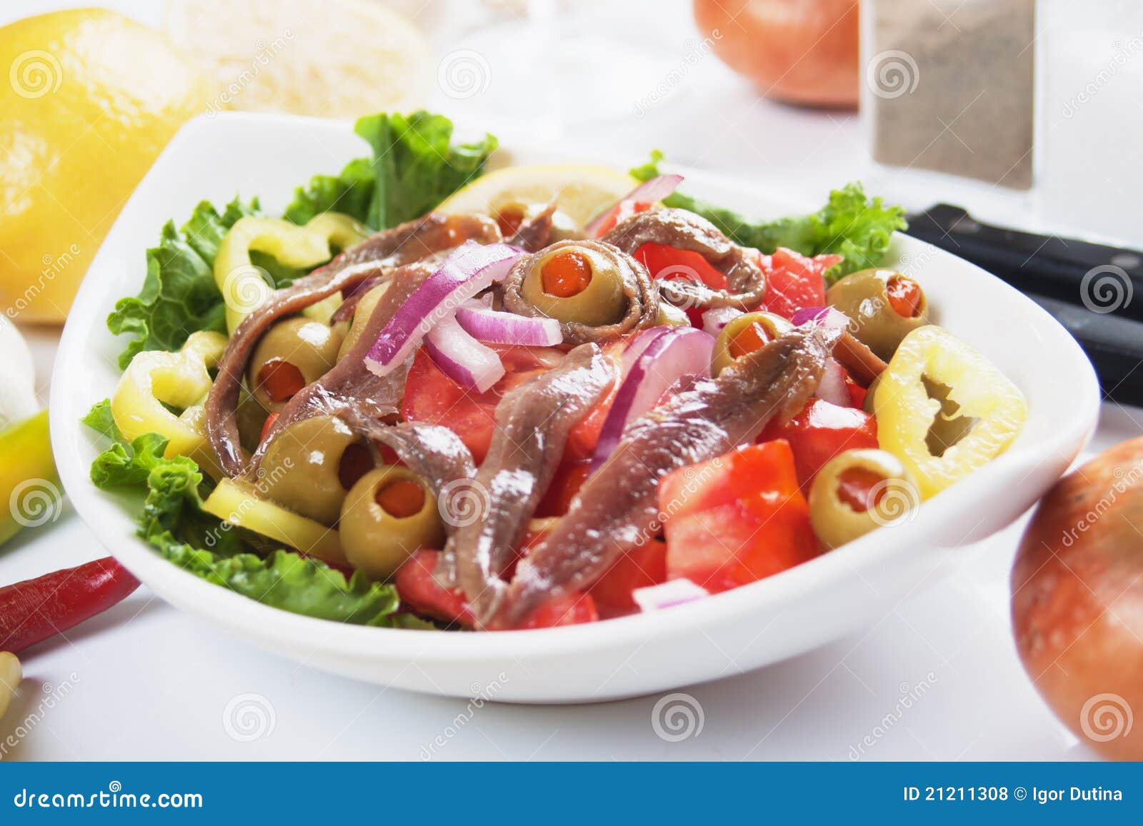 Anchovy salad with olives, tomato, onion and pepper.