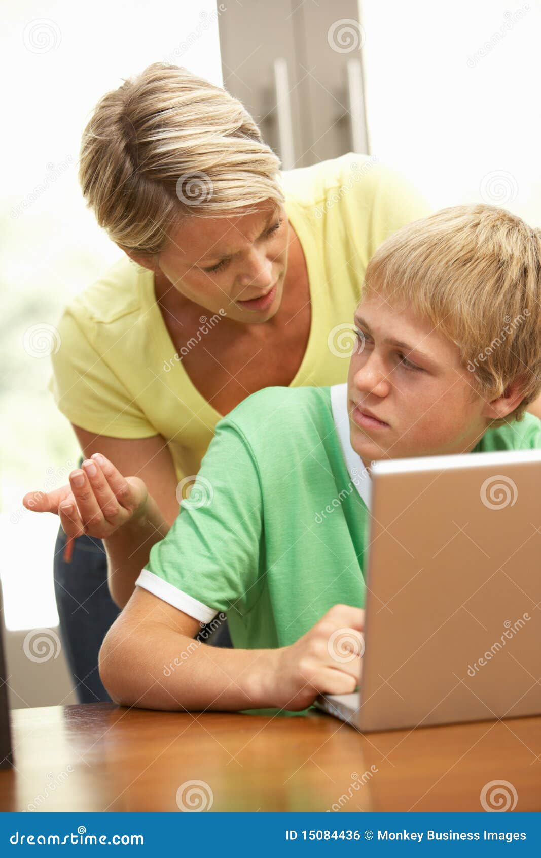 Angry Mother And Teenage Son Using Laptop At Home Royalty Free Stock Image Image 15084436