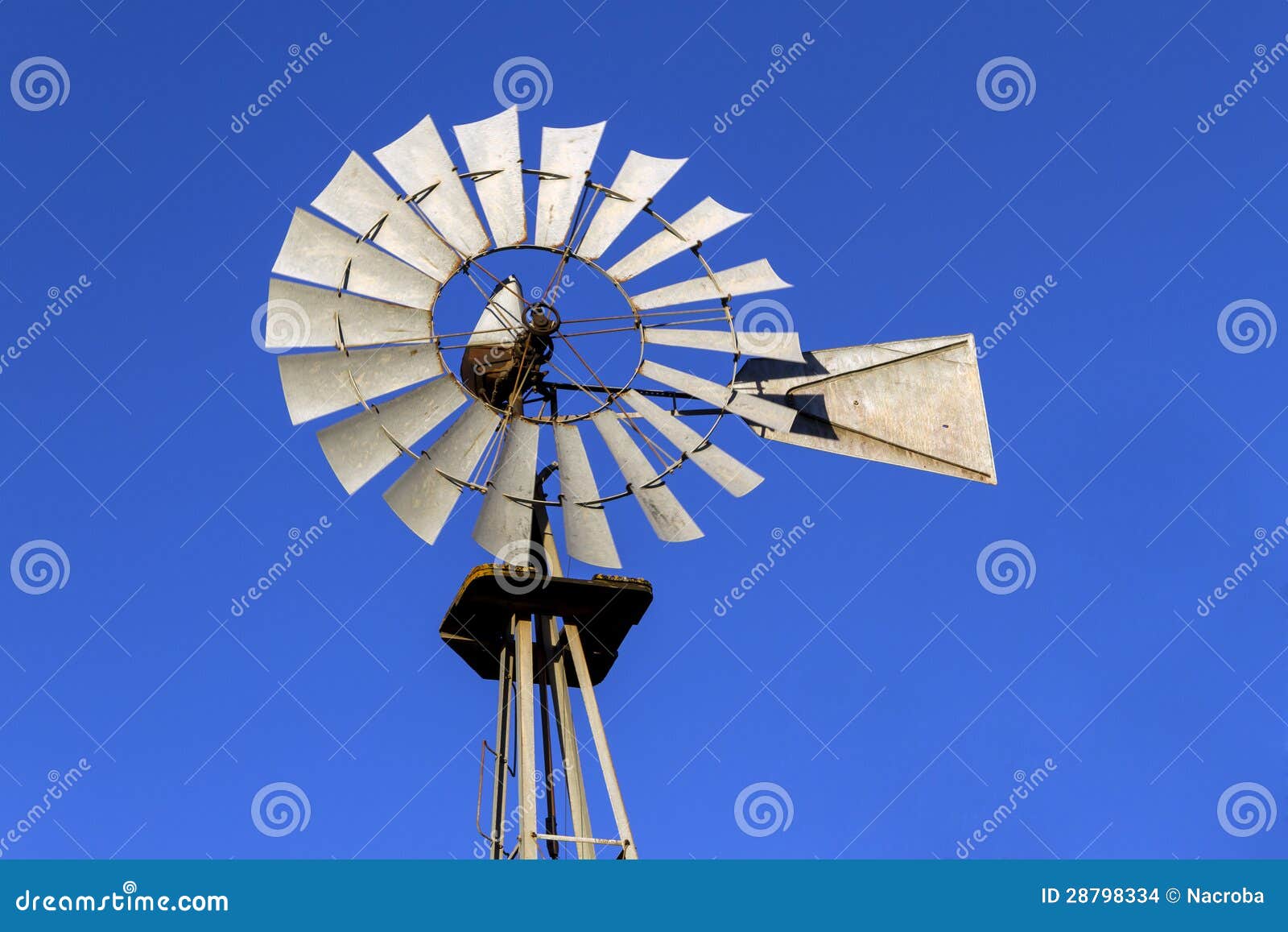 Old antique Aermotor windmill in movement used to pump water for 