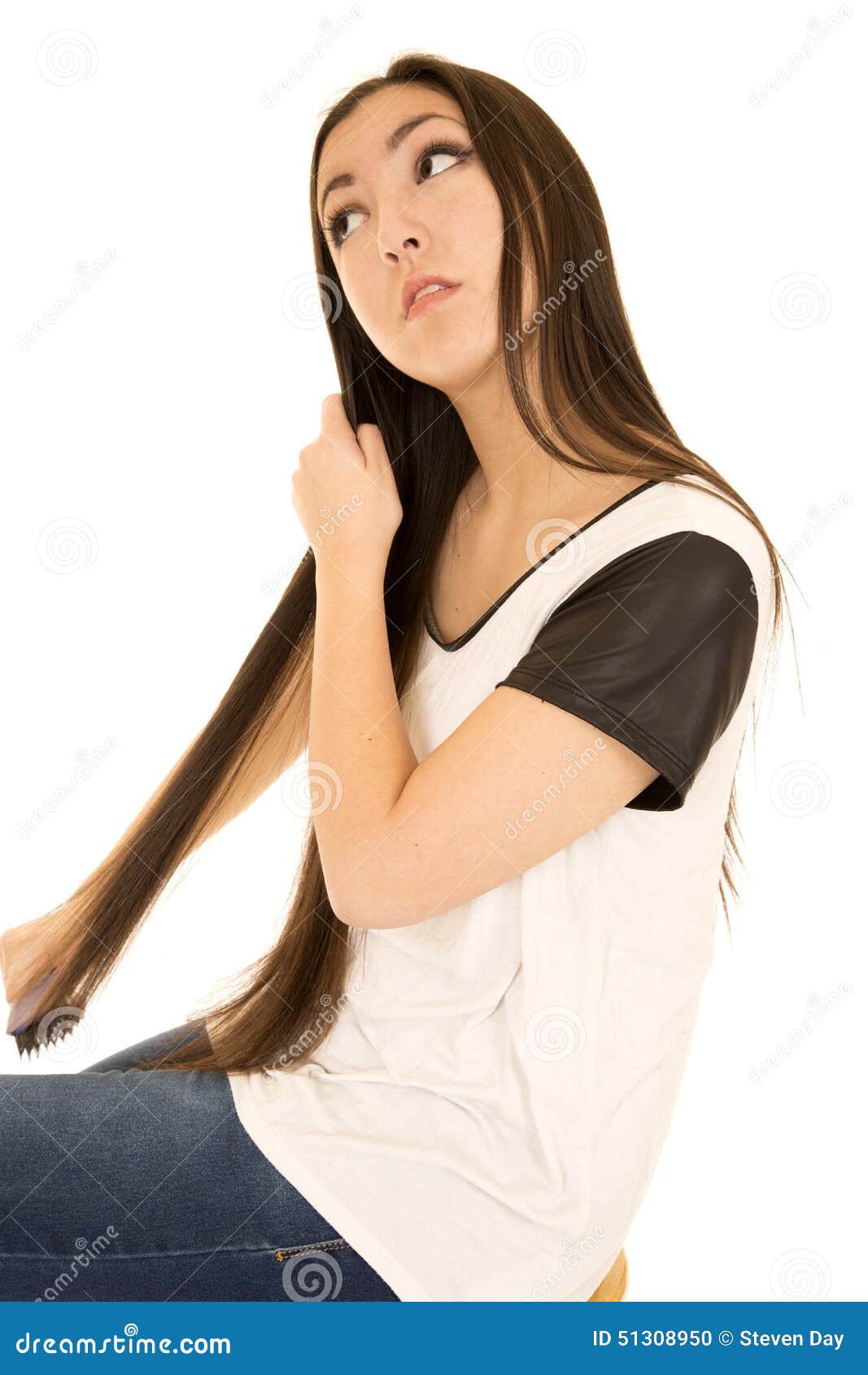 Asian American Teen Brushing Her Long Dark Hair Stock