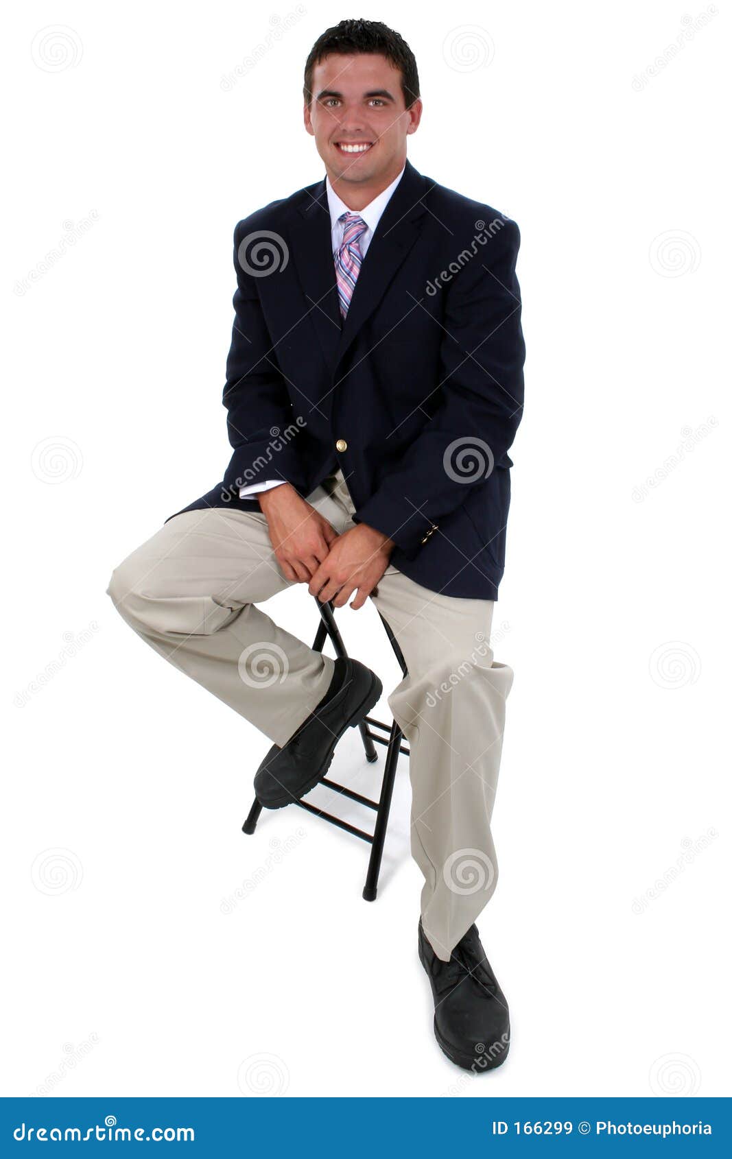 Attractive Businessman Sitting On Stool. Shot in studio over white 