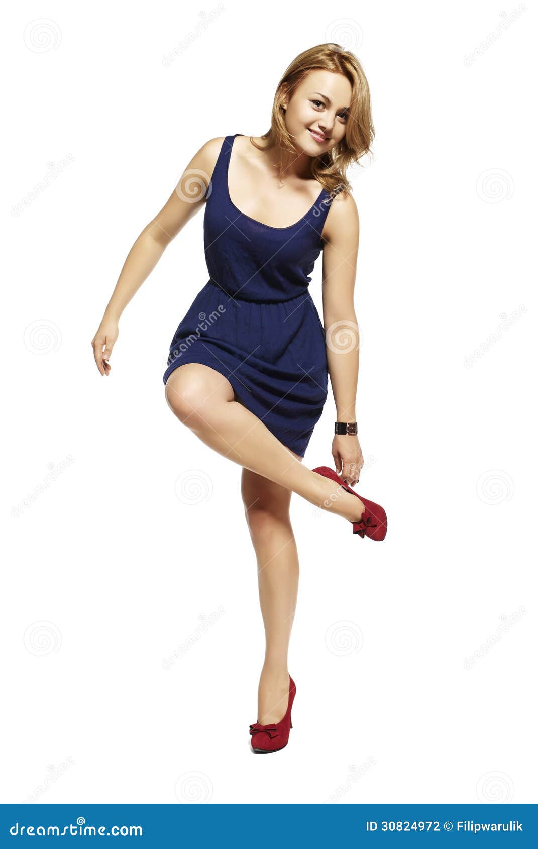 Attractive woman standing on one leg. Studio shot.