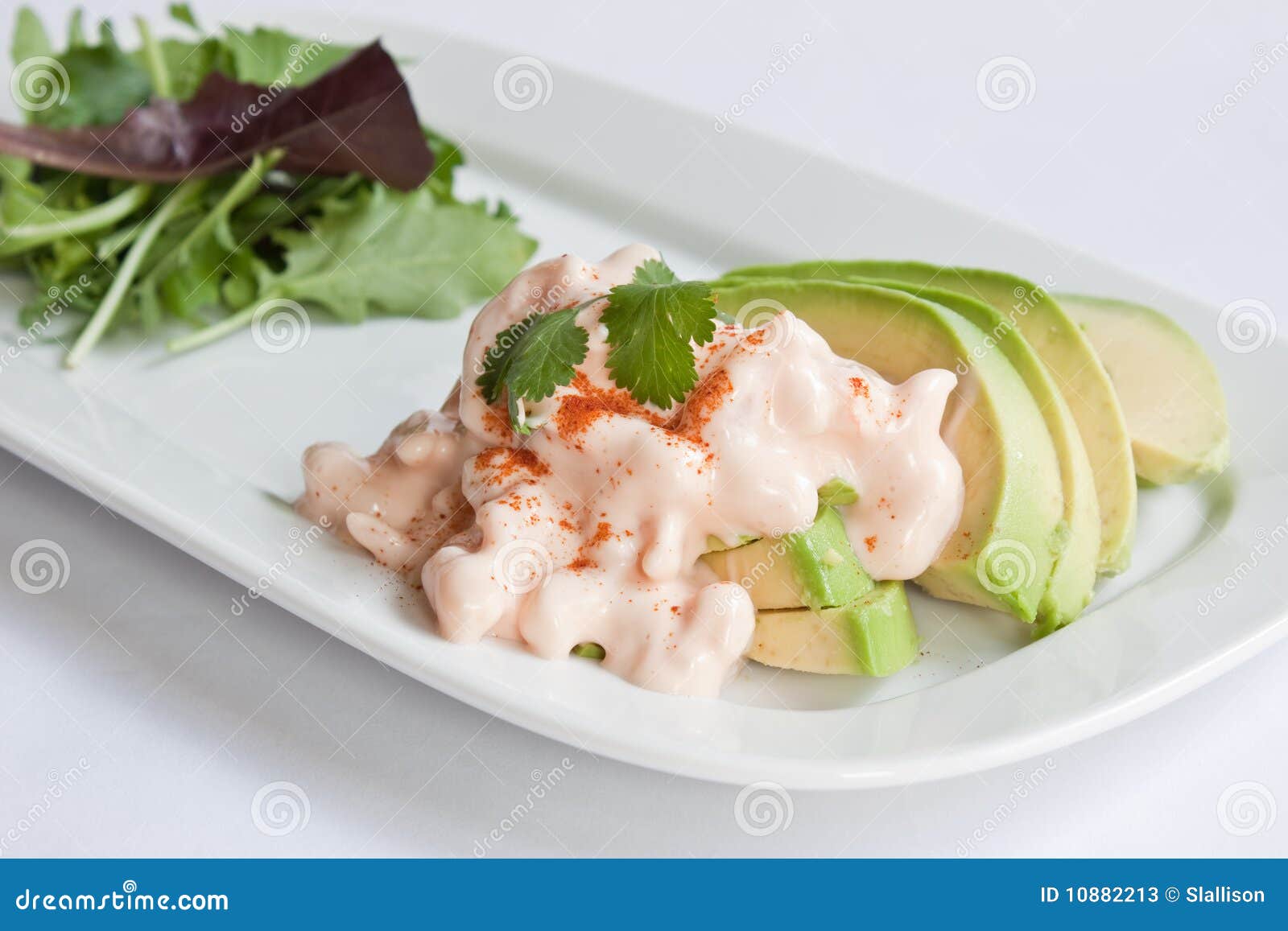 Slices of avocado topped with prawns in a marie rose sauce served with ...