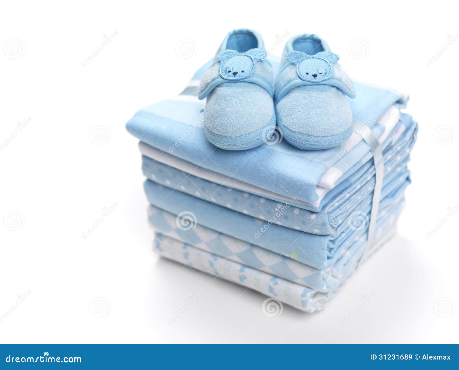Cute blue baby boy shoes on a pile of swaddling blankets isolated on ...