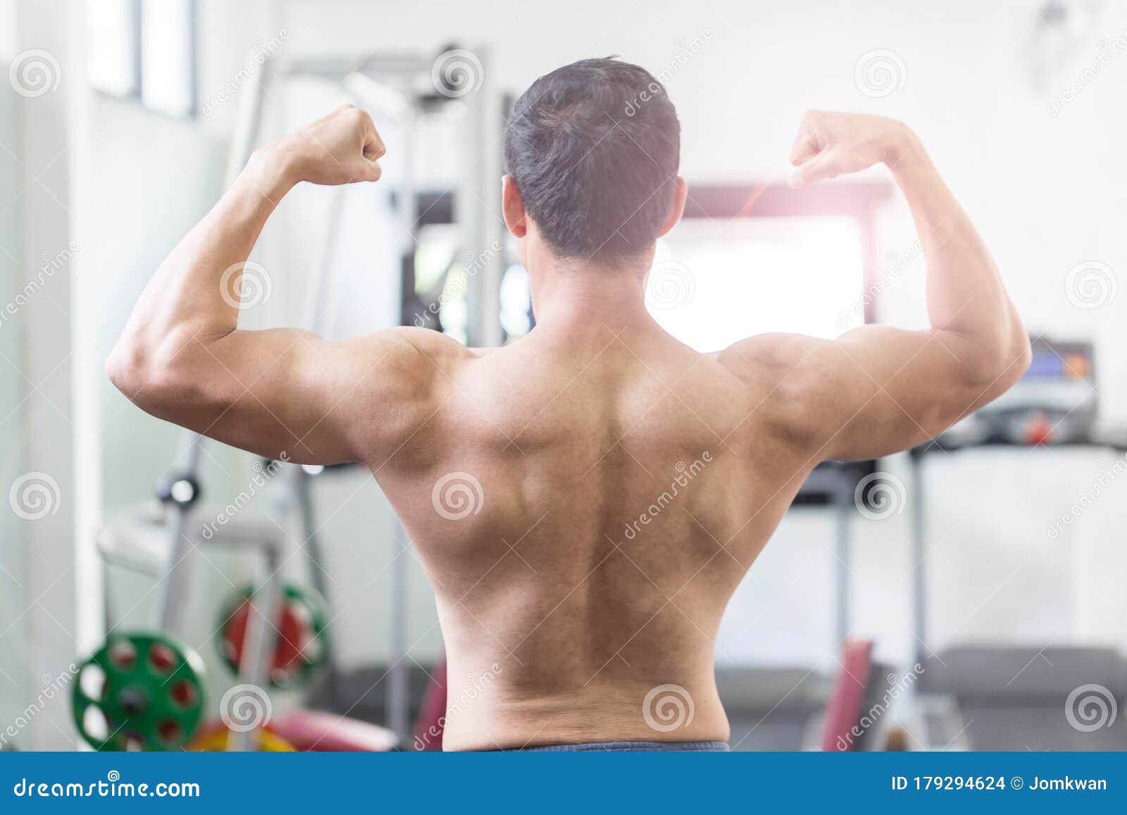 Back Of View Asian Men Doing Bodybuilder Rear Double Biceps Pose In Gym