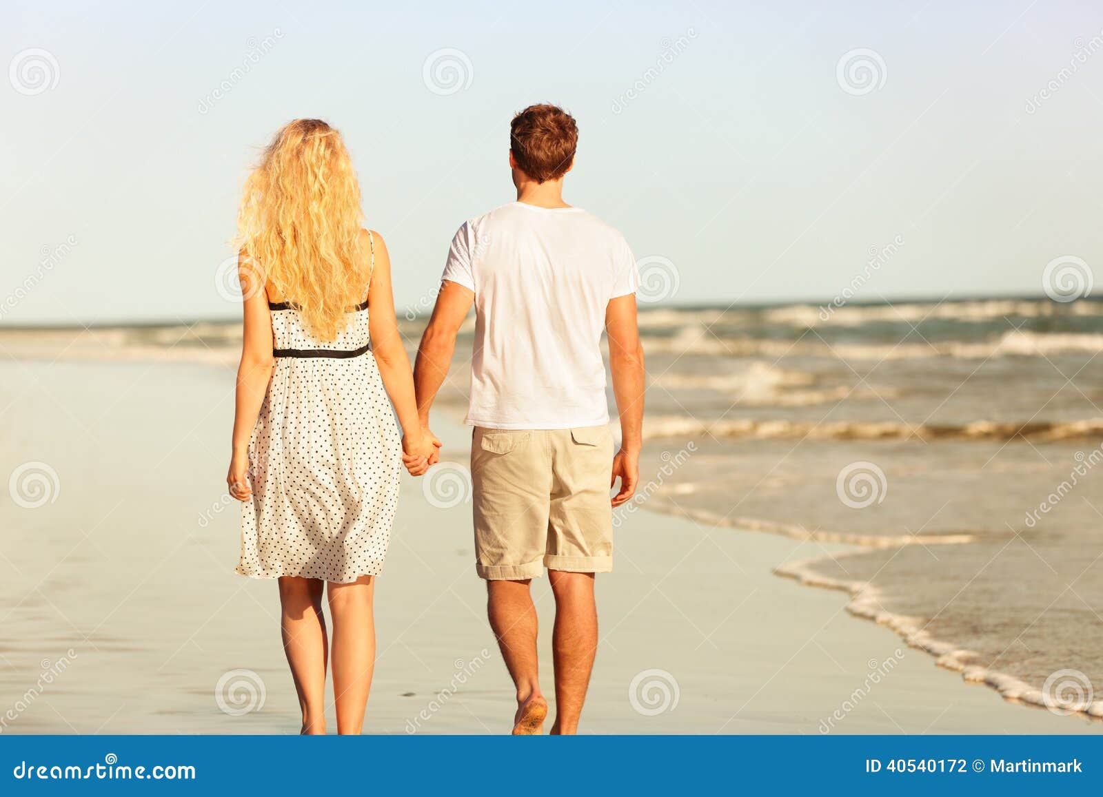 People Walking Away On The Beach