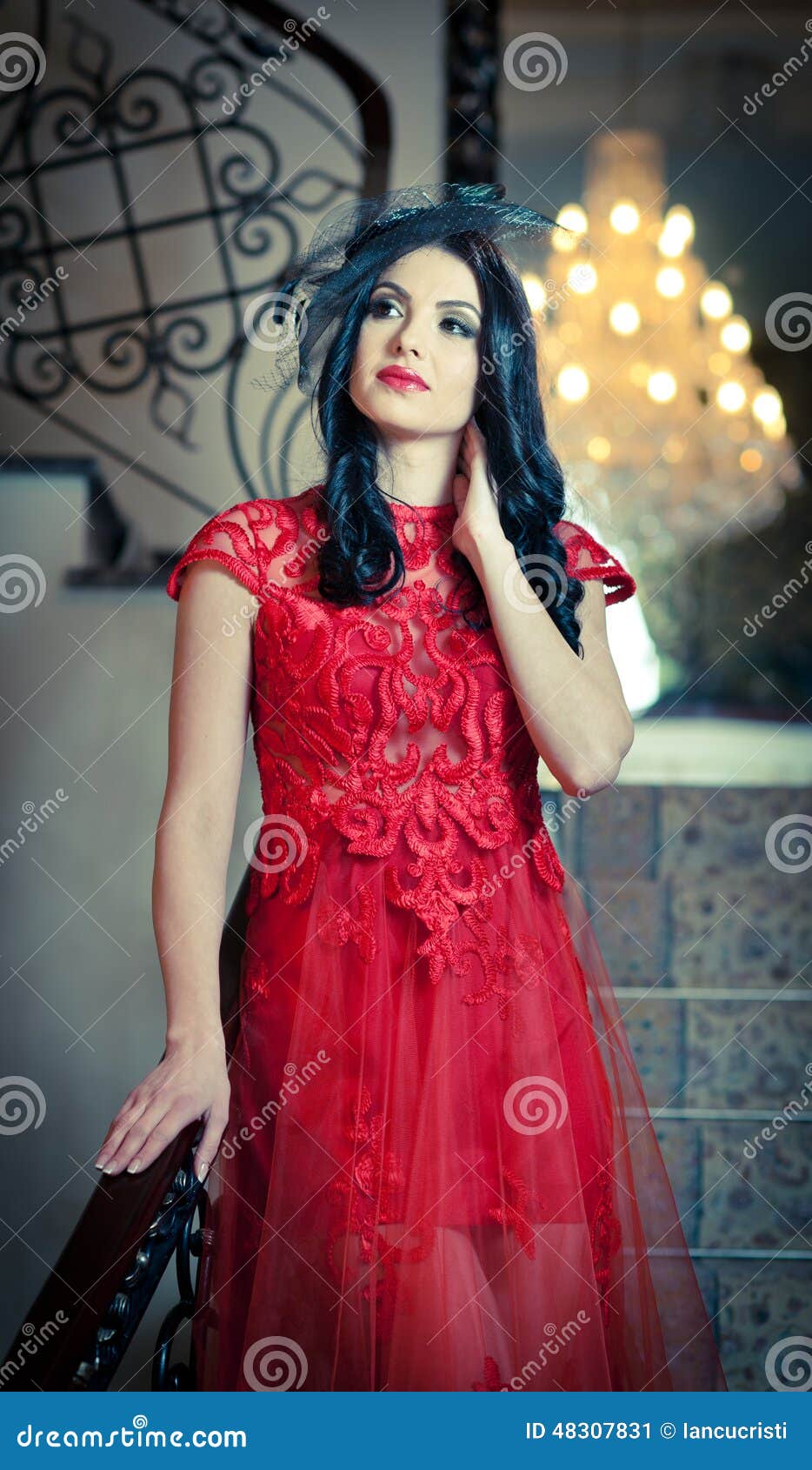 The beautiful girl in a long red dress posing in a vintage scene ... The beautiful girl in a long red dress posing in a vintage scene ...