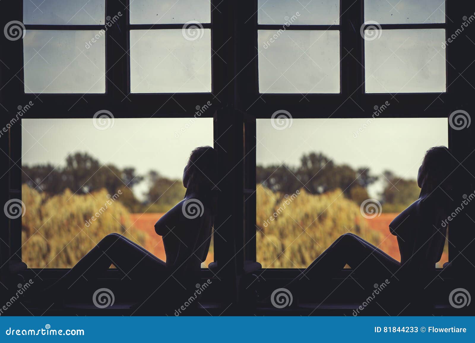 Beautiful Naked Female Sitting On A Window At Sunset Stock Image