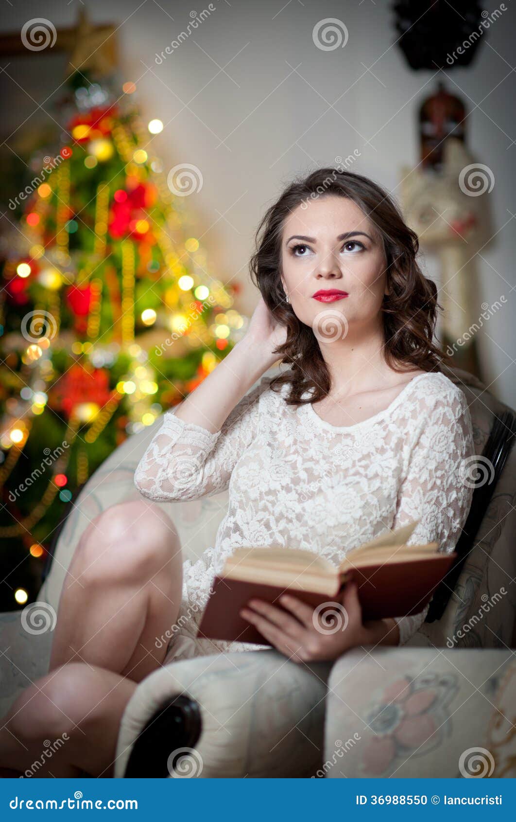 Beautiful Sexy Woman With Xmas Tree In Background Reading