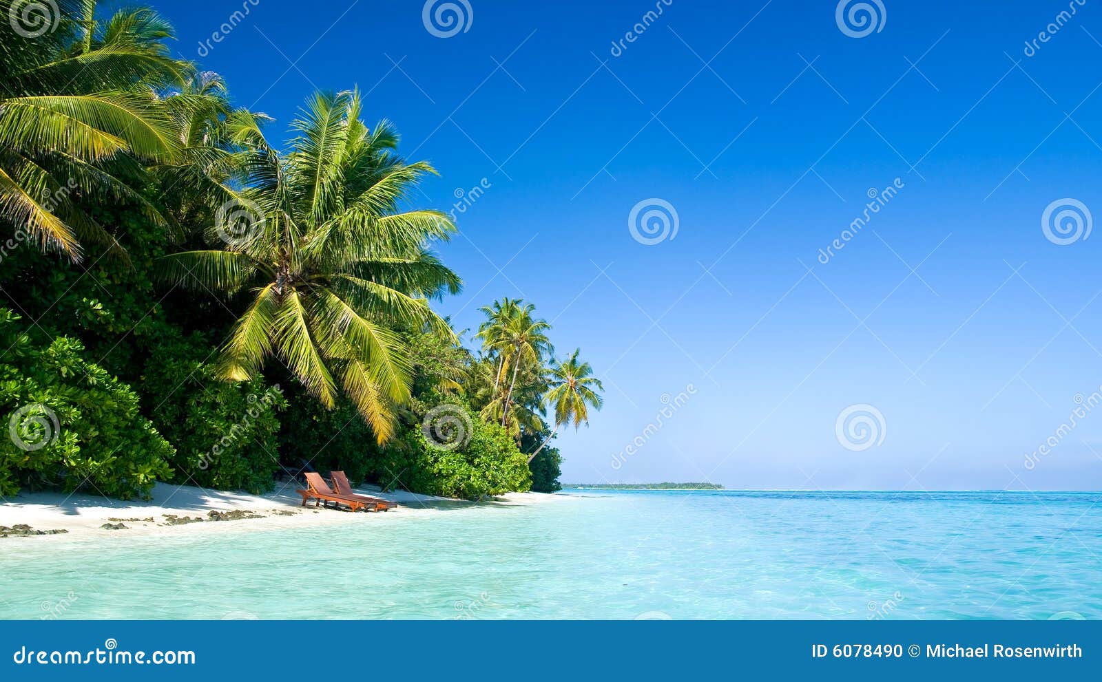 Beautiful tropical beach with deck chairs.