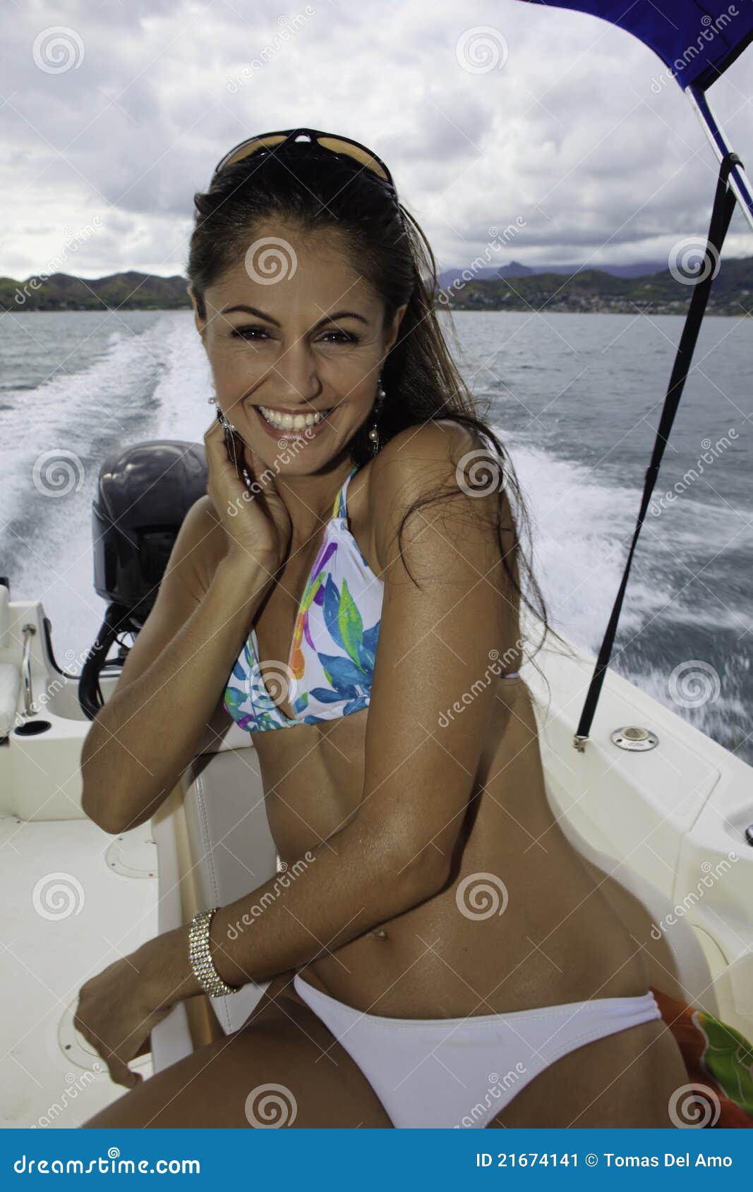 Beautiful woman sitting in a boat cruising in kaneohe bay, hawaii.
