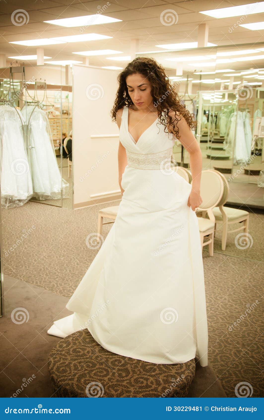 Beautiful woman trying a white bridal wedding dress before getting ...