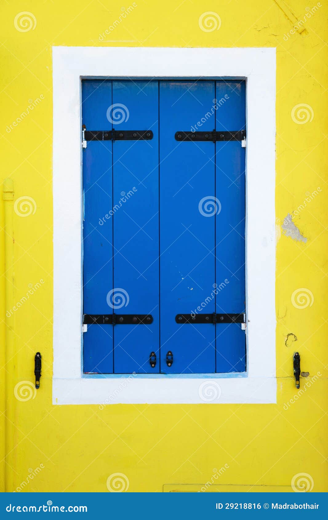 Blue Window Shutters On A Yellow House Wall Royalty Free Stock ...