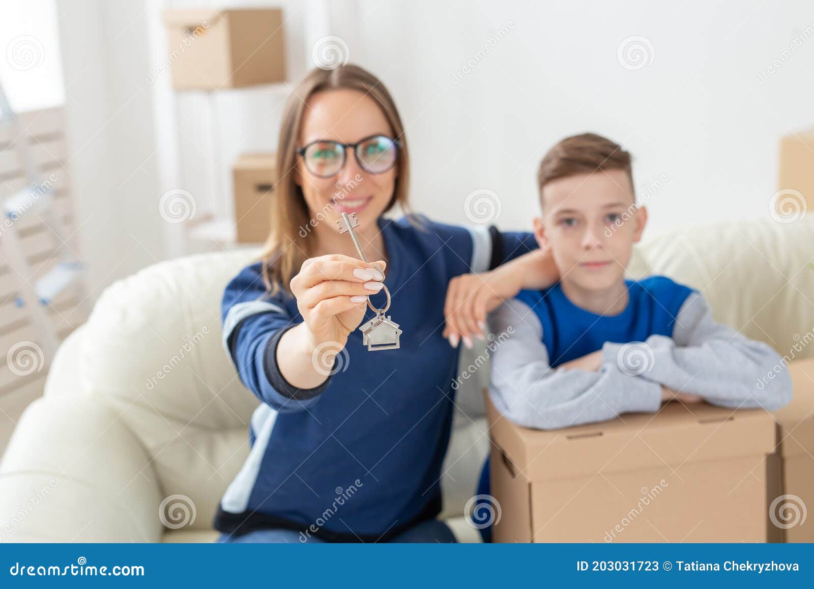 Blurry Good Looking Mom And Son Are Holding The Keys To A New Apartment