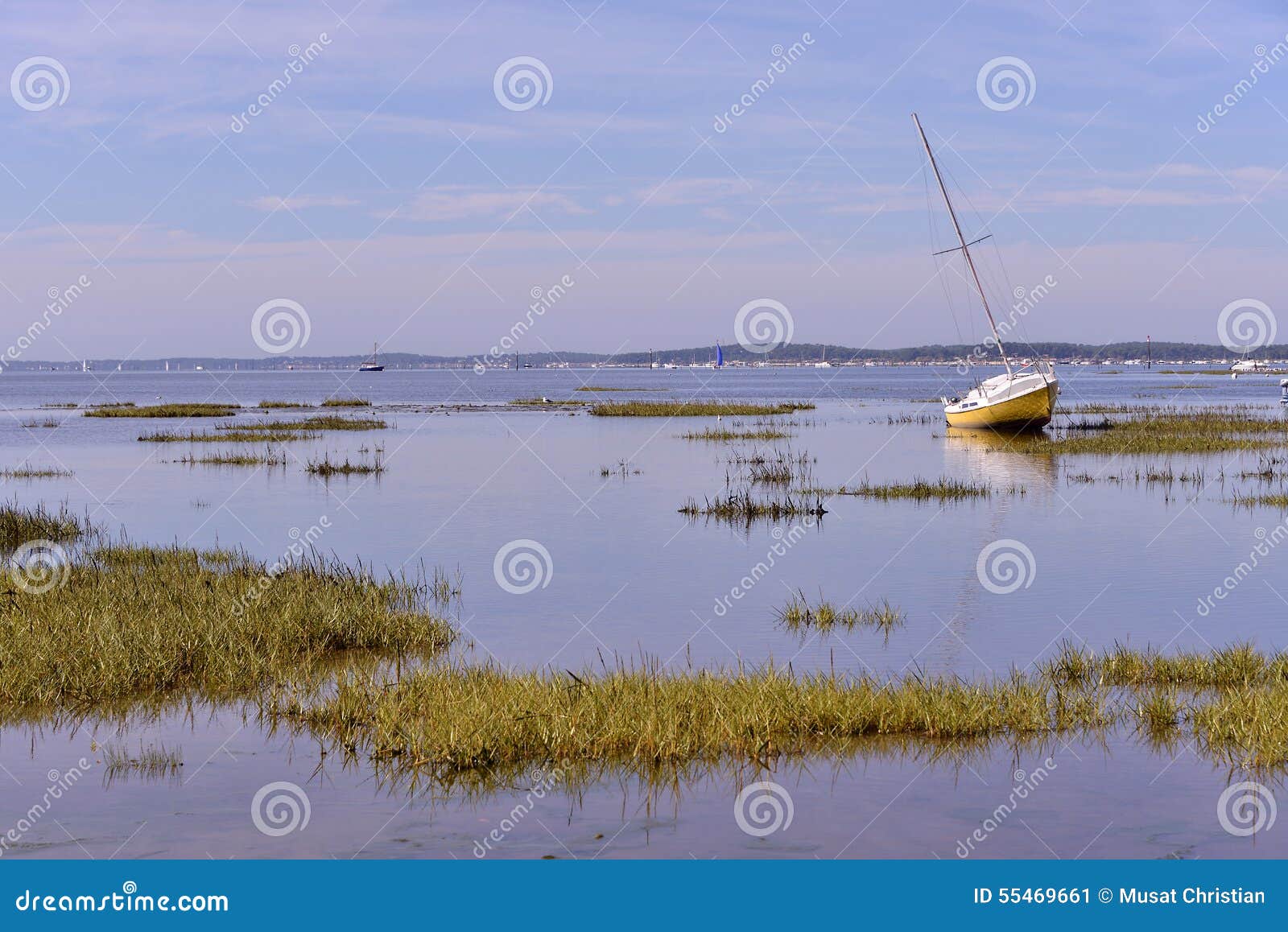 Sailboat at low tide at Arès, ostreicole commune located on shore of 