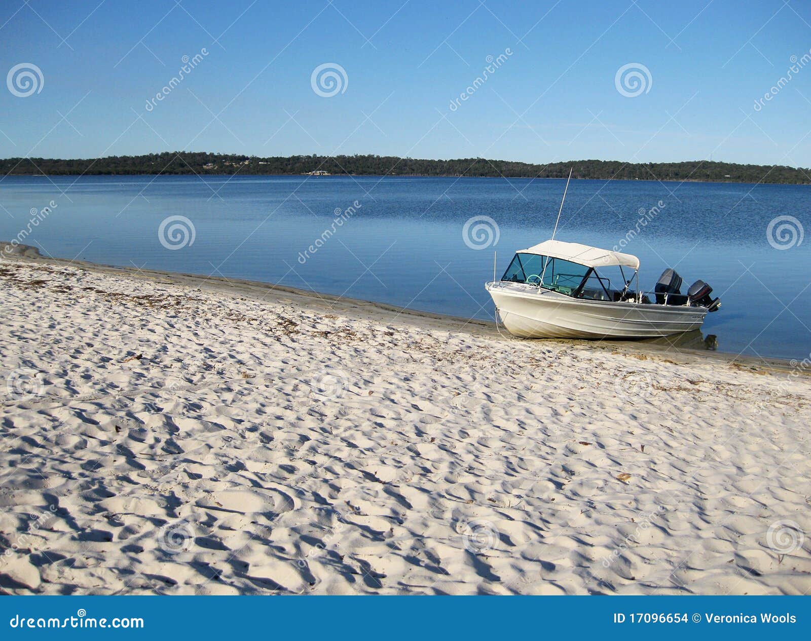 An aluminium dinghy resting on the sand on the foreshore of the Peel 