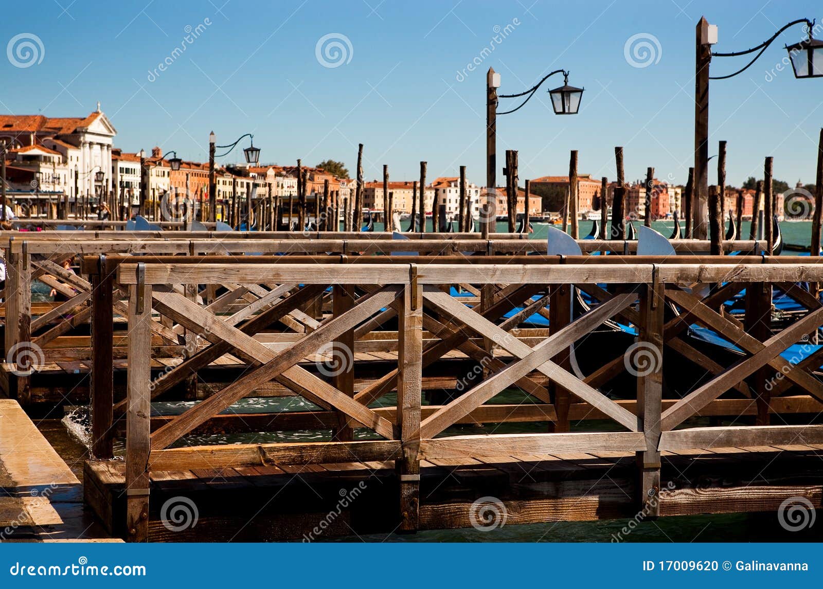 Boat (gondola) landing in Venice with a wooden railing.