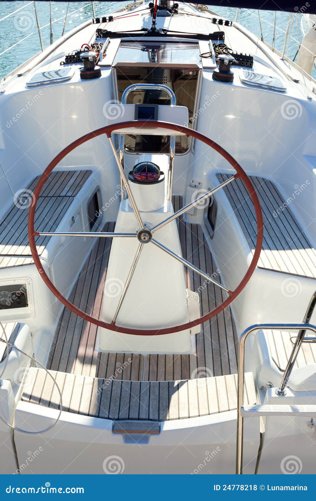 Boat stern with big steering wheel and sailboat stern deck.