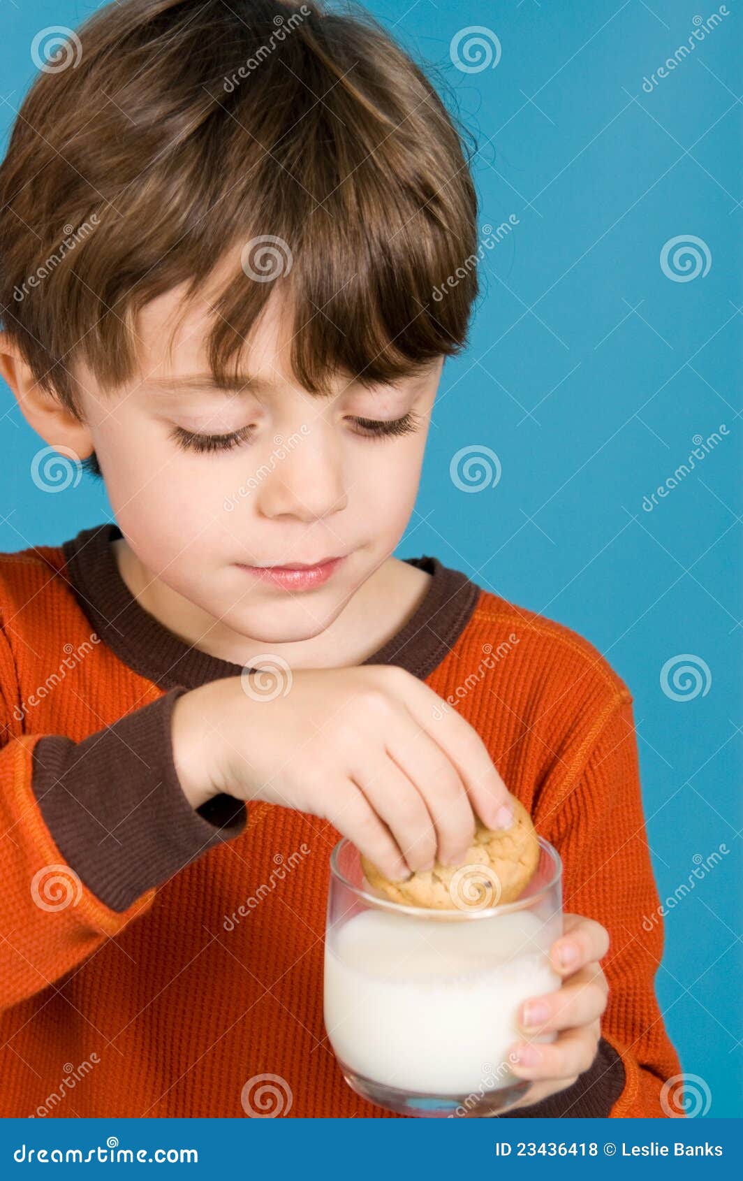 Boy eating cookies and milk - boy-eating-cookies-milk-23436418
