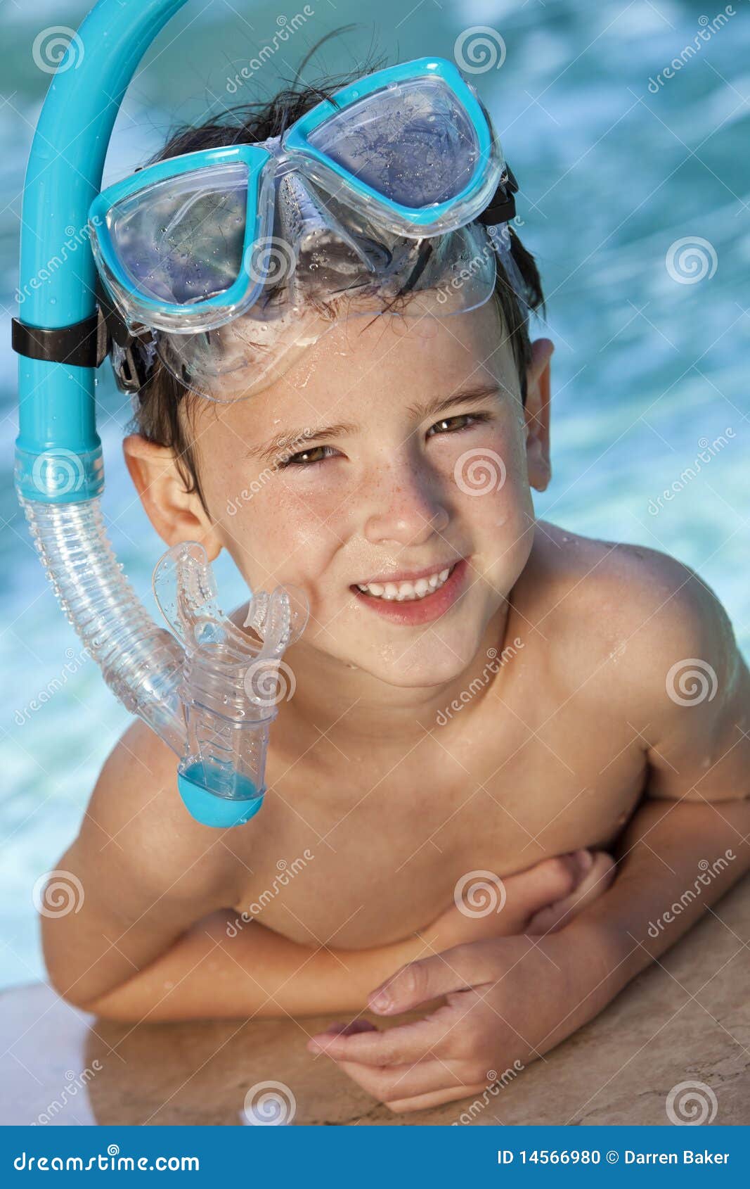 Teenage Boy Wearing Goggles And Towel At Swimming Pool 