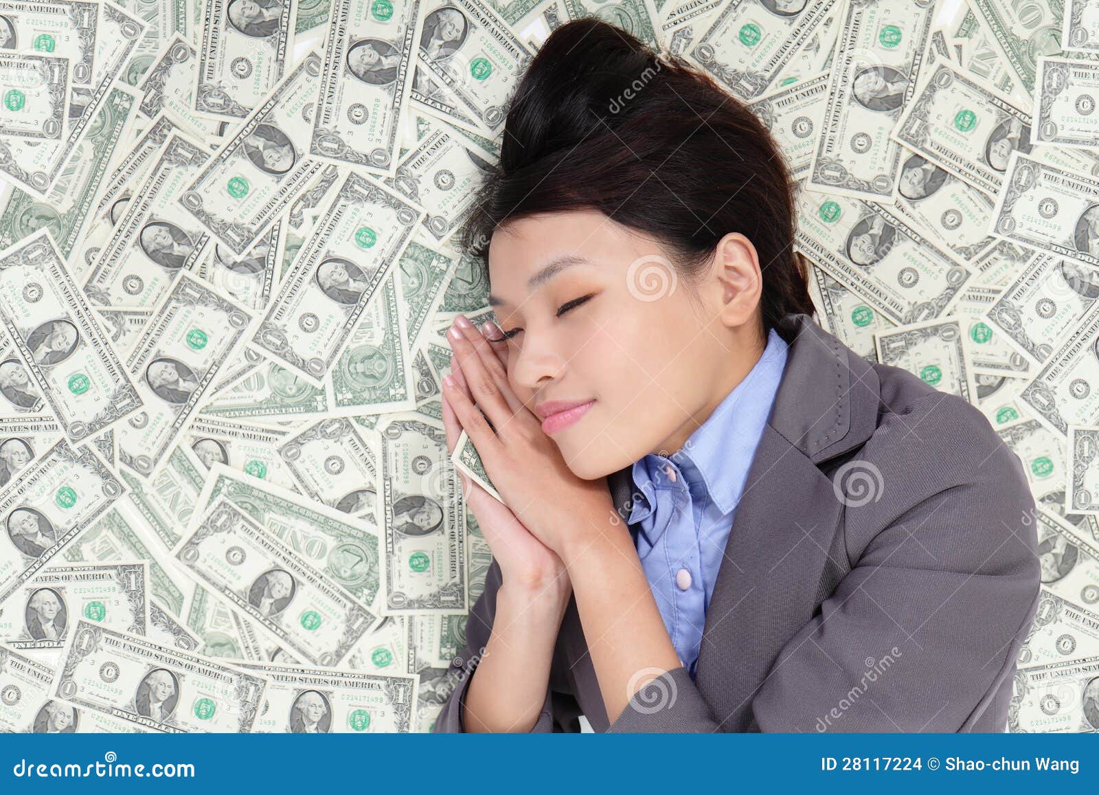 Young business woman sleeping on money bed and have a good dream ...