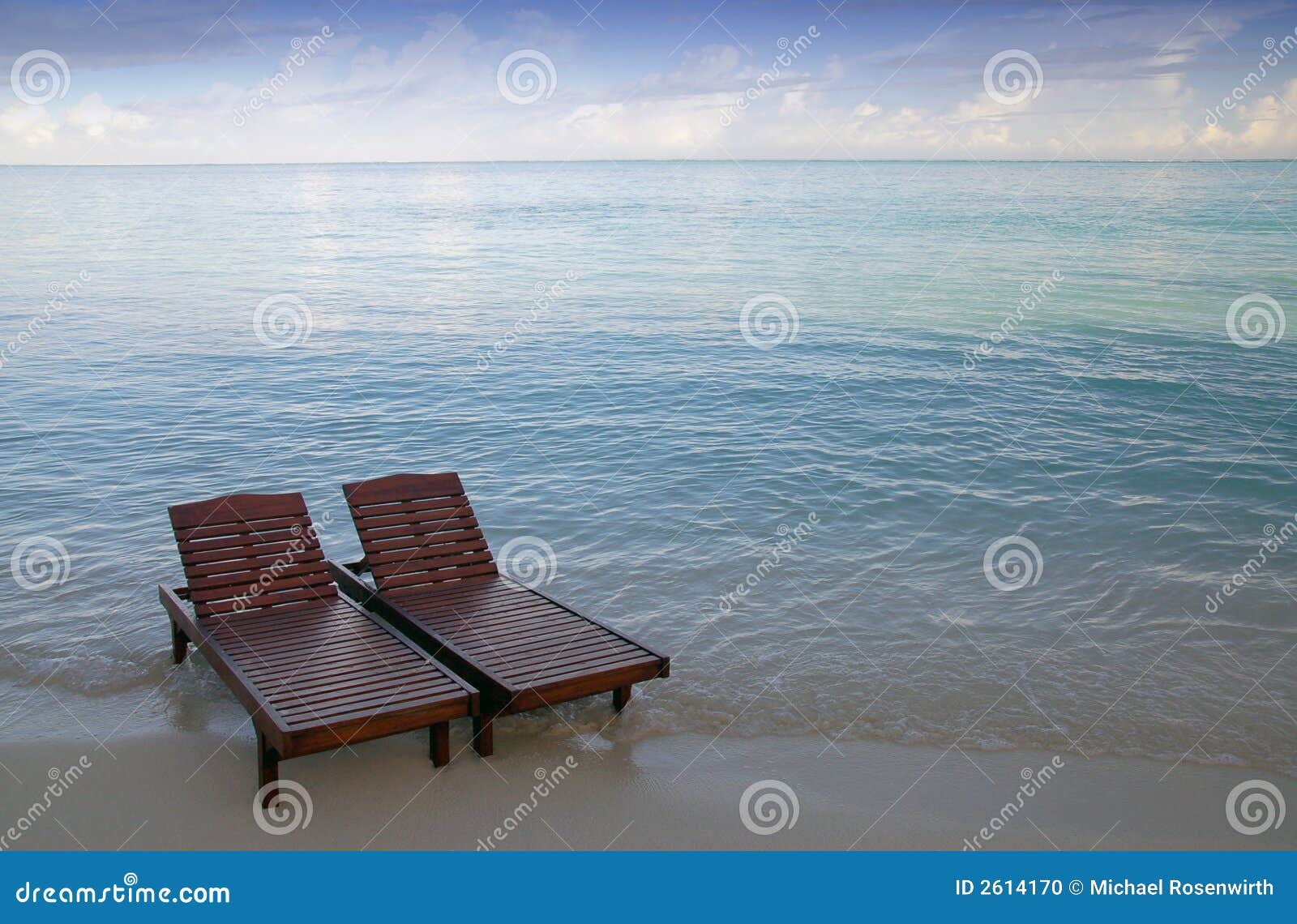 Canvas chairs on tropical beach.