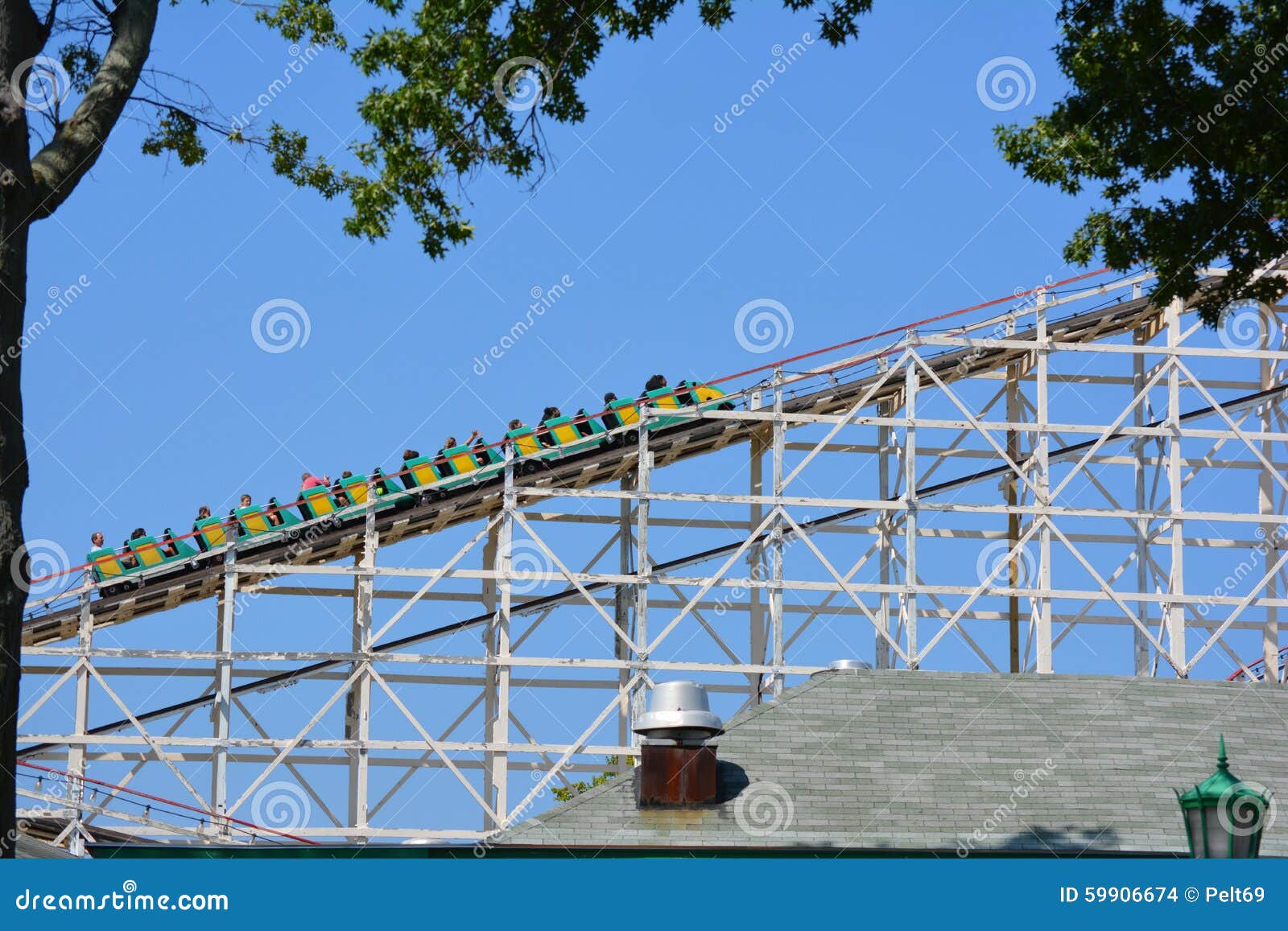 Vintage Backyard Roller Coaster : on rails of old wooden roller coaster against blue skies on sunny day Vintage Backyard Roller Coaster : on rails of old wooden roller coaster against blue skies on sunny day