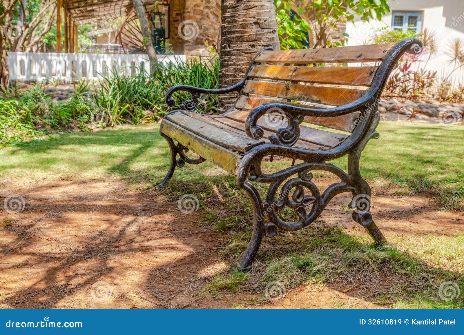 Horizontal color landscape of a wooden slat cast iron frame park bench 