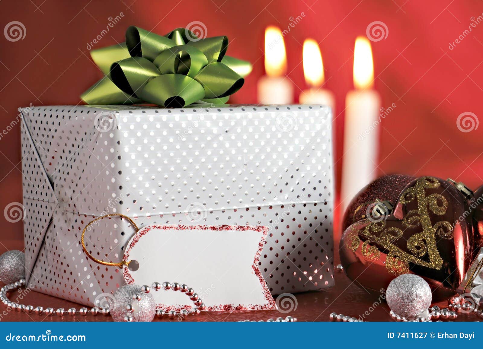 Christmas decorations and gift package with blank name tag in front of ...