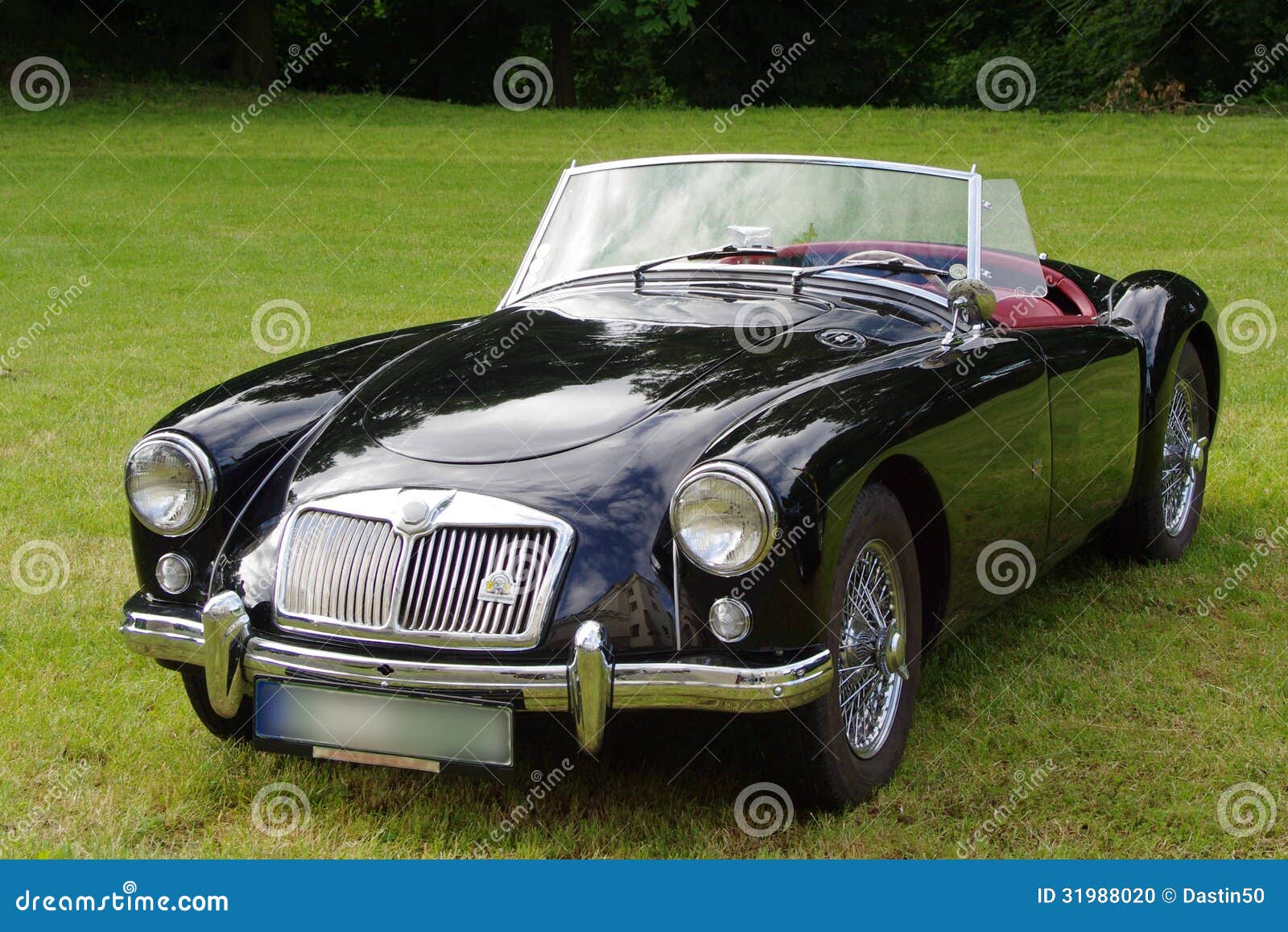 Antique, convertible MG sports car with the top down.