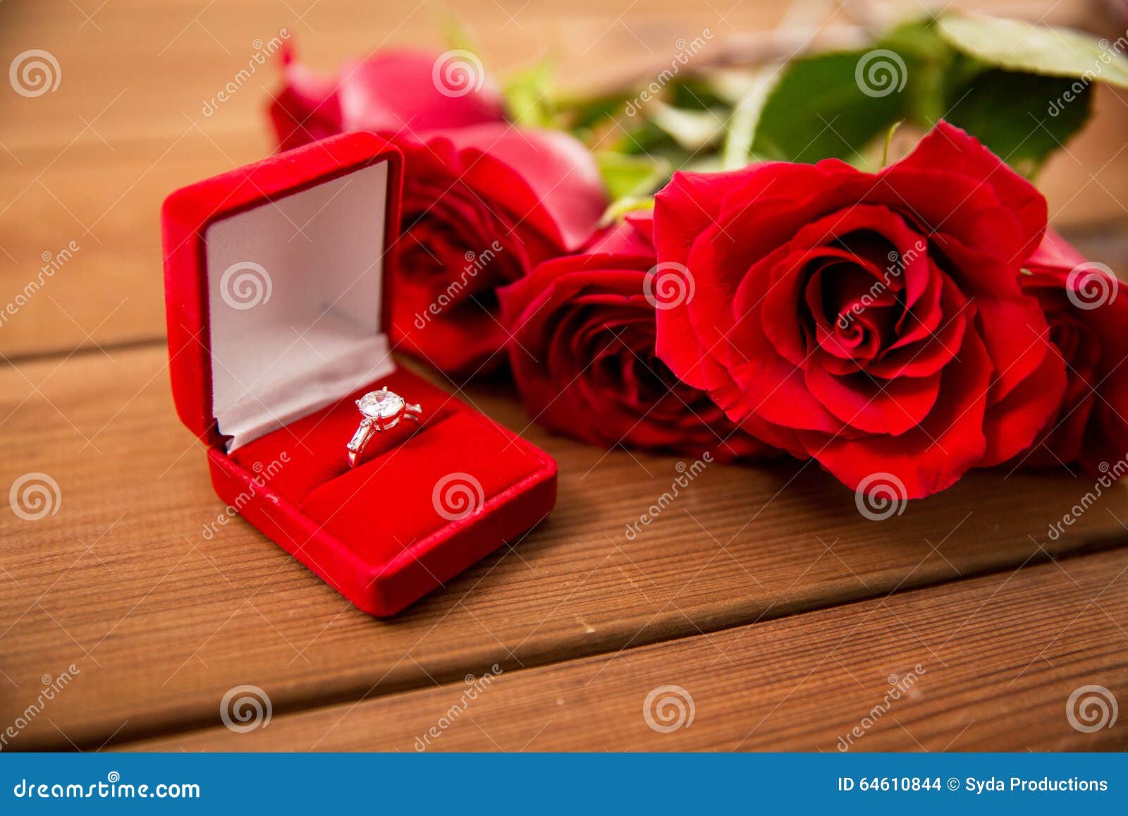 Close Up Of Diamond Engagement Ring And Red Roses Stock Photo - Image 