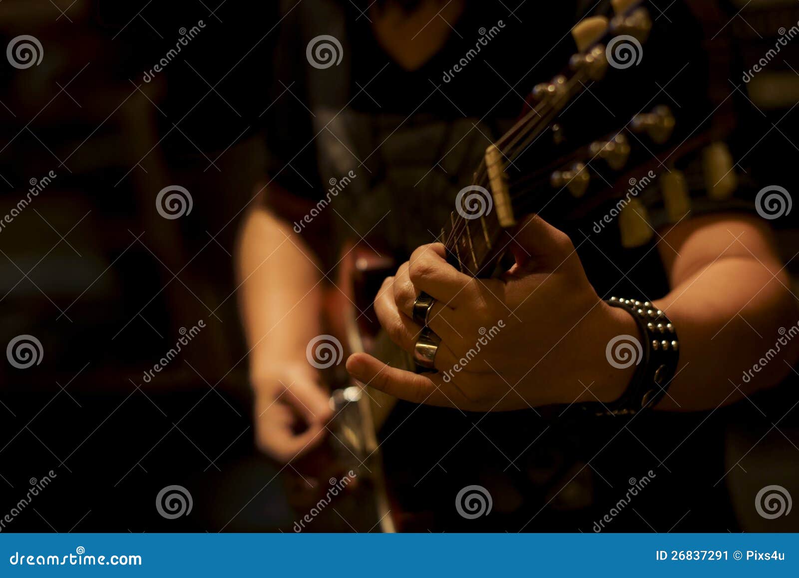 Close up musician playing electric guitar, Dark Background.