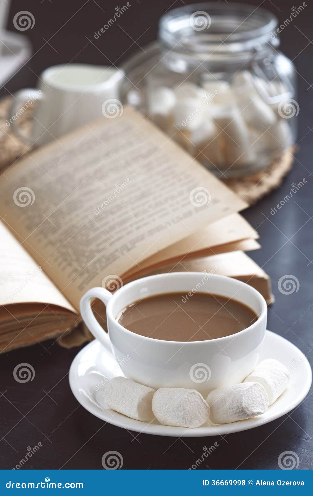 Cup of hot coffee and vintage book on a table, selective focus.