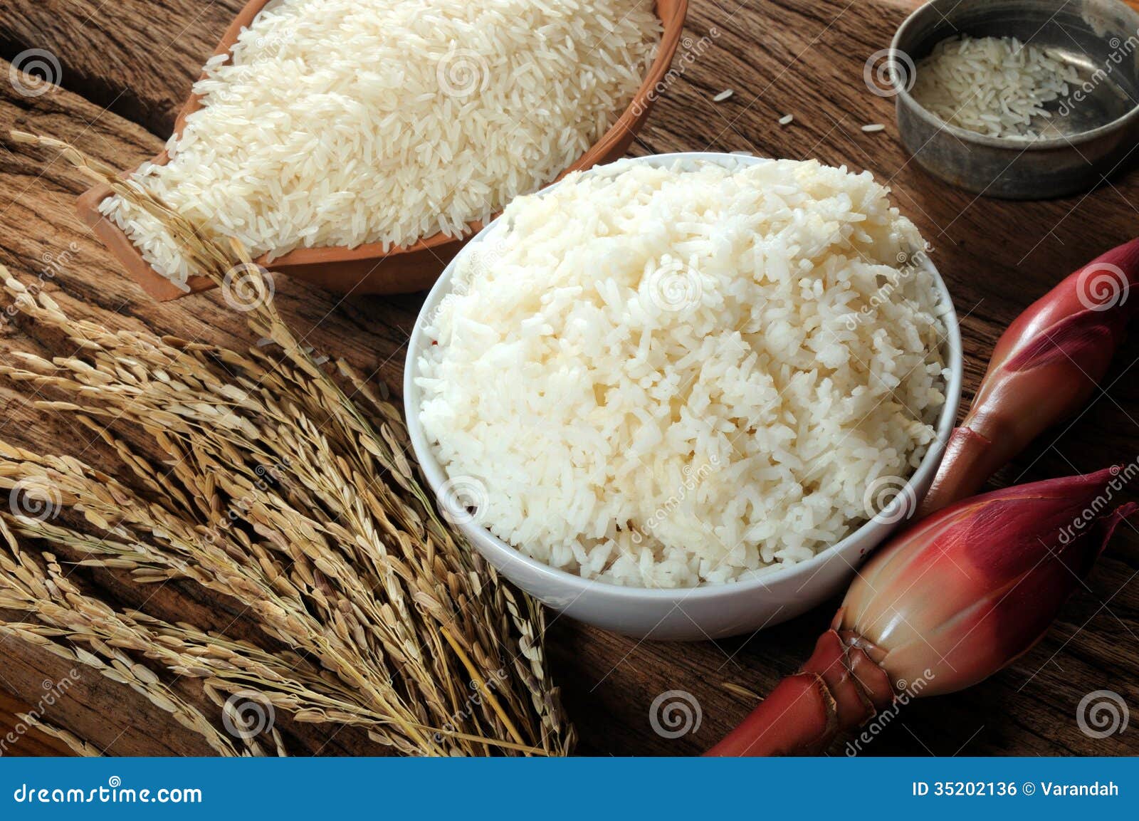 Cooked Rice, Uncooked Rice And Paddy Rice On Wooden Tabel Royalty Free