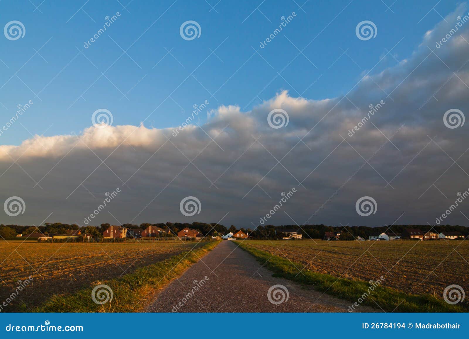Picture of a country landscape with a country path leading to a ...