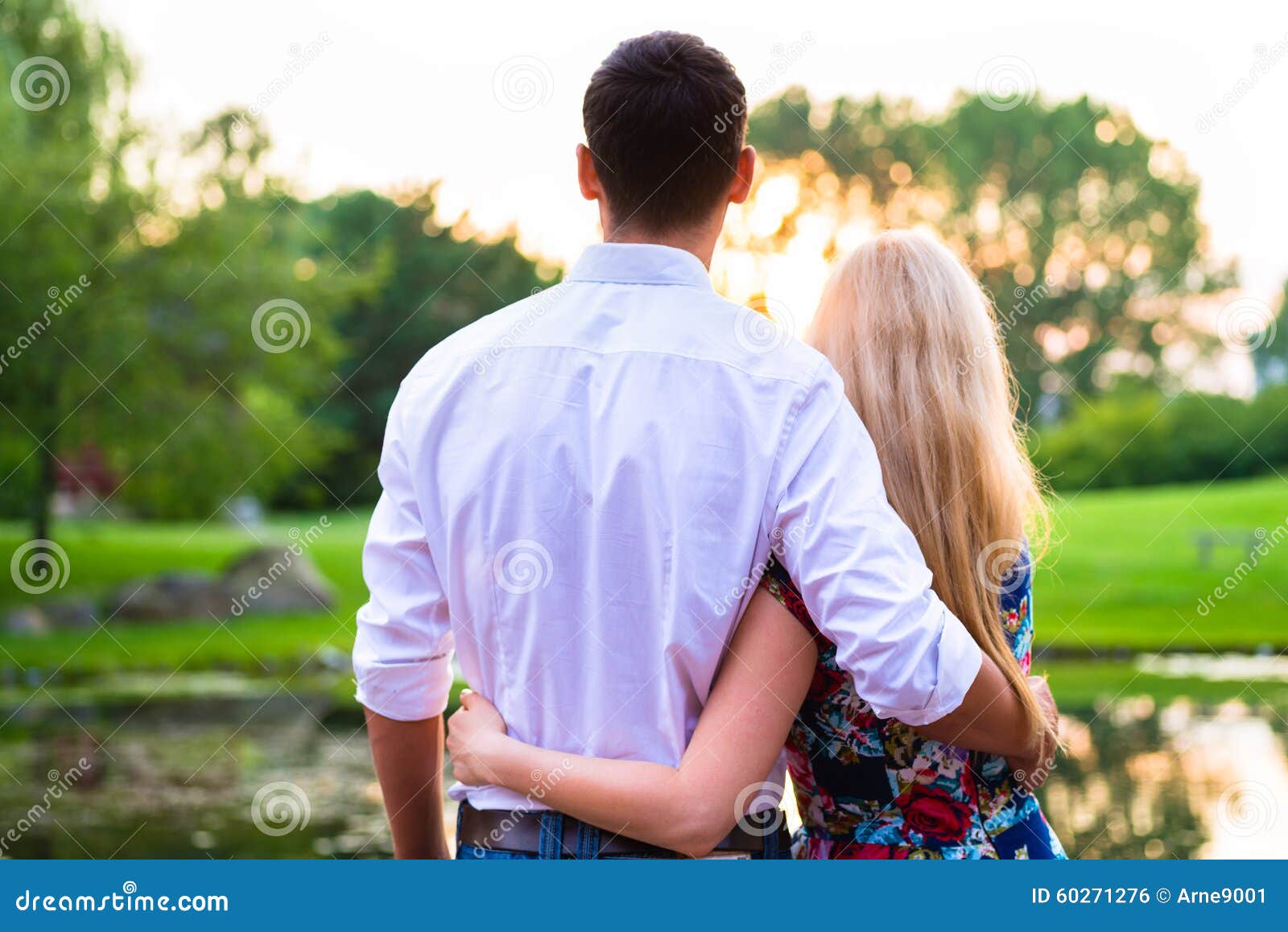 Couple Dreaming Their Life Together Looking In Sunset Stock Photo
