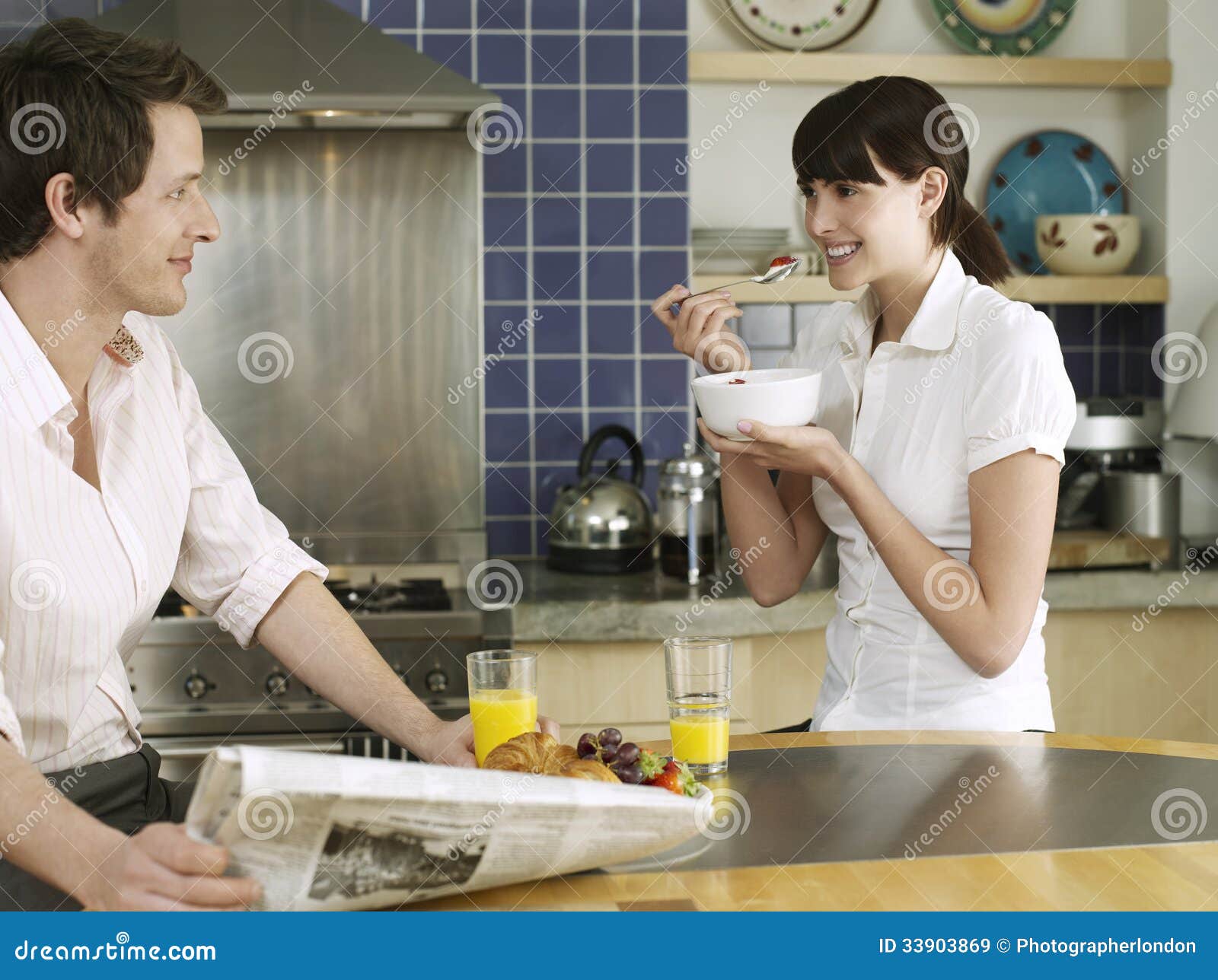 Couple Having Breakfast At Kitchen Table Royalty Free Stoc