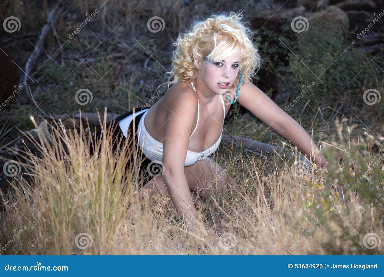 Woman Crawling Through Undergrowth Stock Photo Image Of Grasses