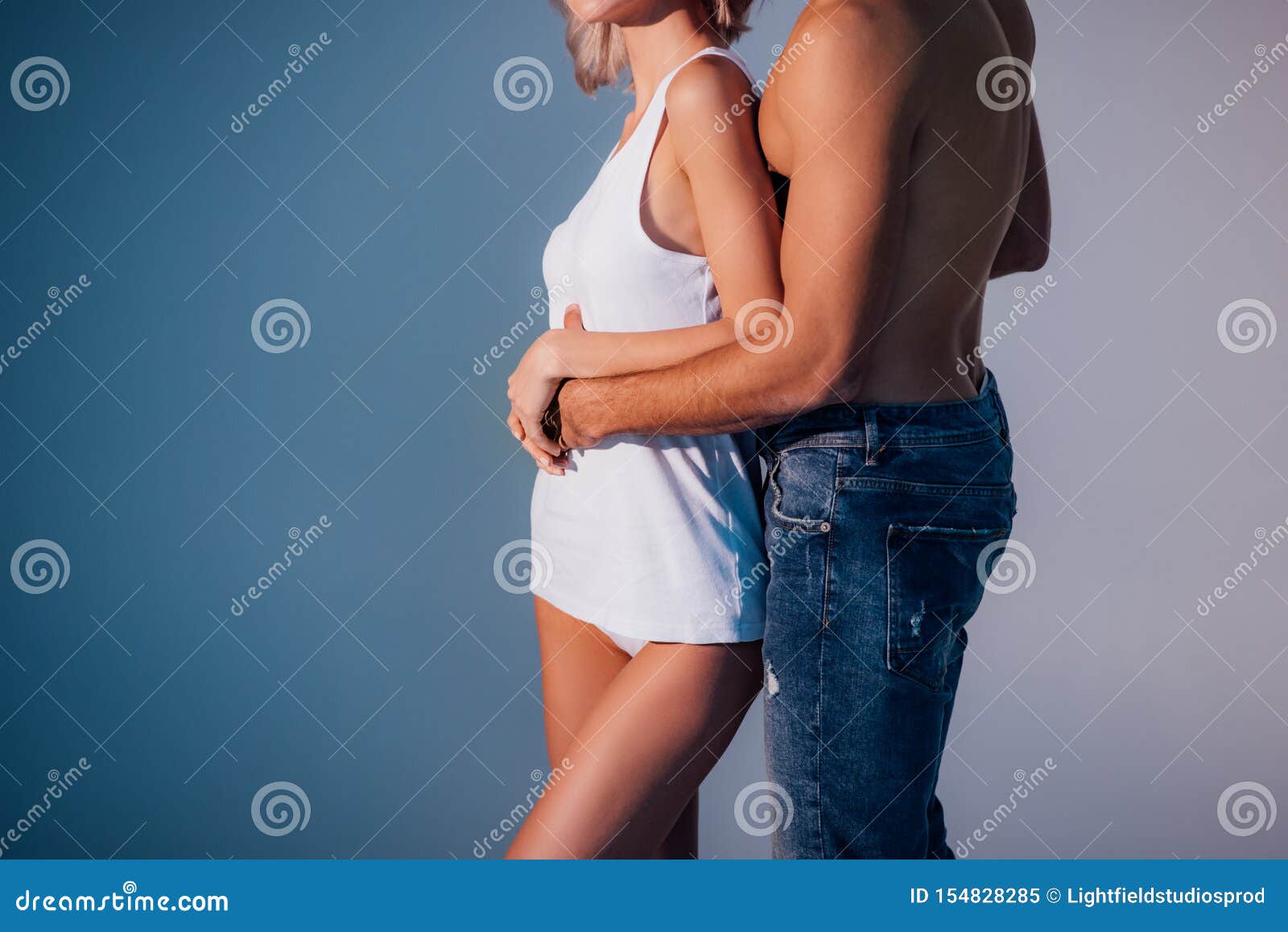 Cropped View Of Shirtless Man Hugging Woman From Behind Stock Image