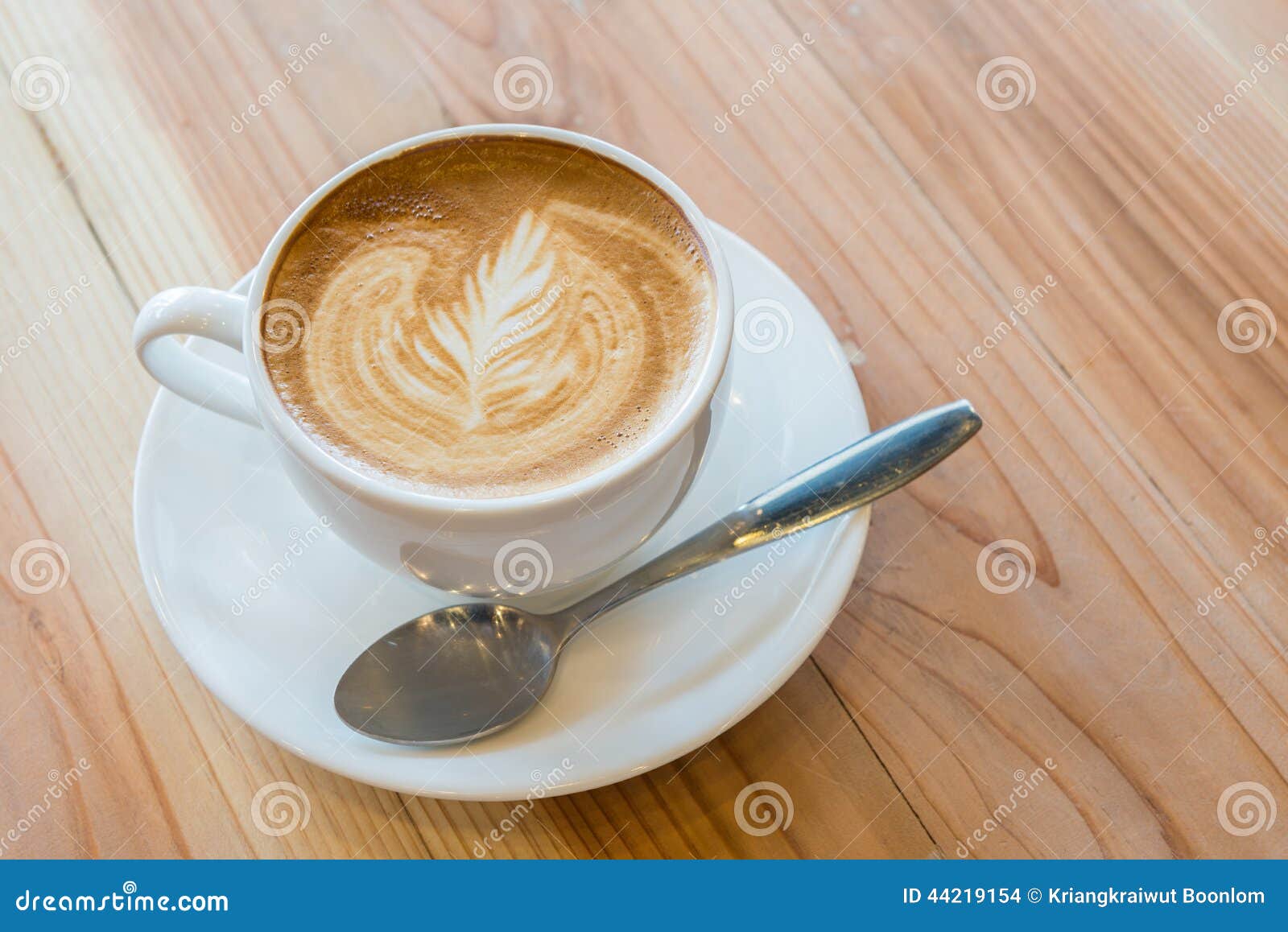 Leaf Pattern In Coffee | a cup of coffee with leaf pattern in a white cup stock Leaf Pattern In Coffee | a cup of coffee with leaf pattern in a white cup stock
